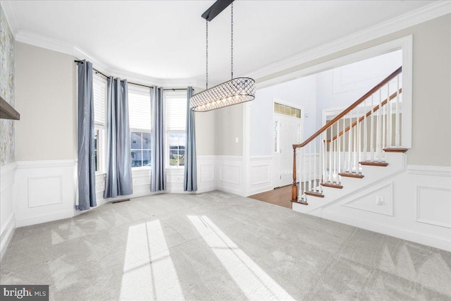 interior space featuring carpet and ornamental molding