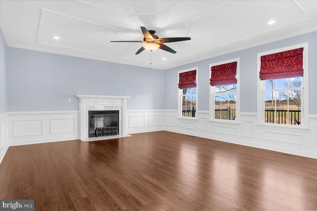 unfurnished living room featuring a fireplace, hardwood / wood-style floors, ceiling fan, and ornamental molding