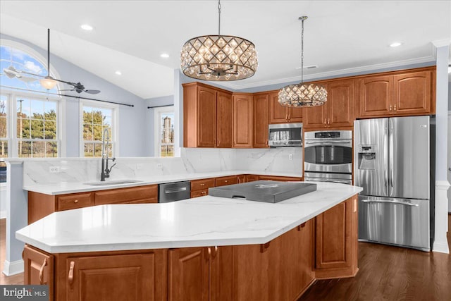 kitchen featuring pendant lighting, vaulted ceiling, and appliances with stainless steel finishes