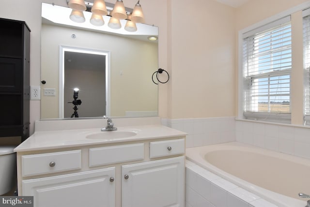 bathroom with vanity and a relaxing tiled tub