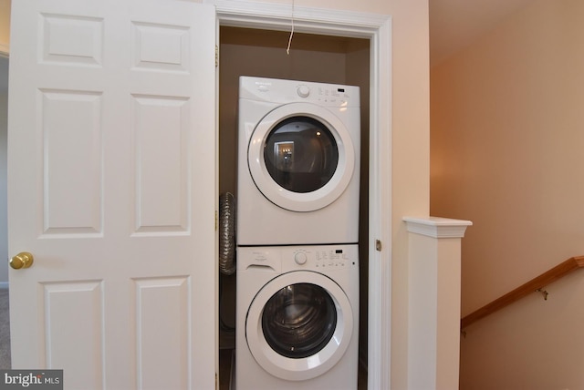 laundry area with stacked washer / dryer