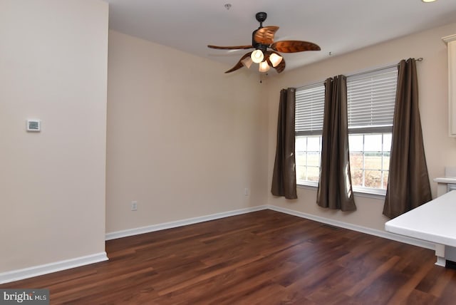 empty room with dark hardwood / wood-style floors and ceiling fan