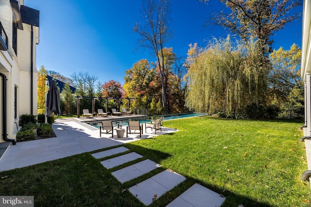 view of yard featuring a fenced in pool and a patio area