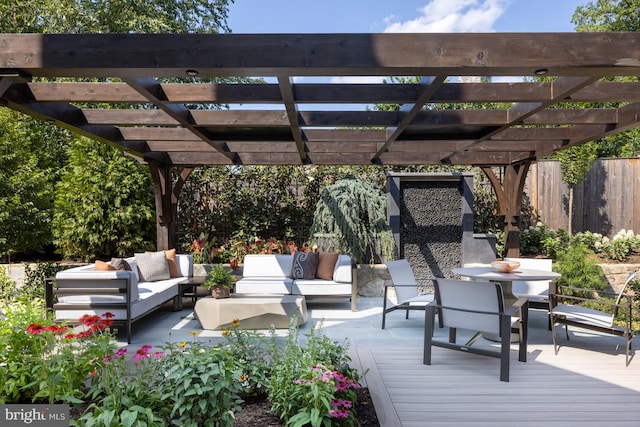 deck with an outdoor living space and a pergola