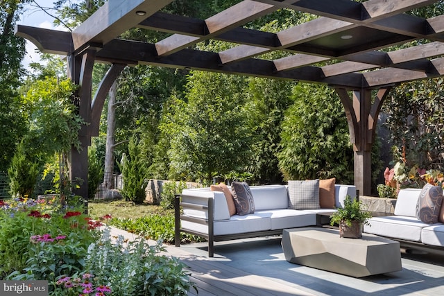 view of patio featuring outdoor lounge area, a wooden deck, and a pergola