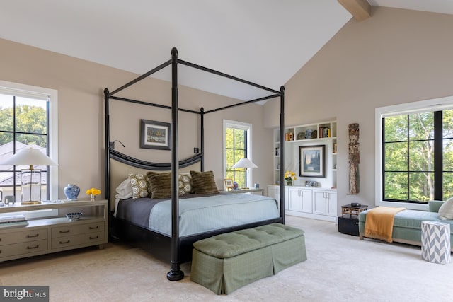 carpeted bedroom featuring high vaulted ceiling and beamed ceiling