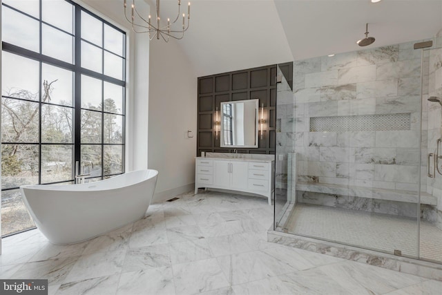 bathroom featuring vanity, shower with separate bathtub, an inviting chandelier, and high vaulted ceiling