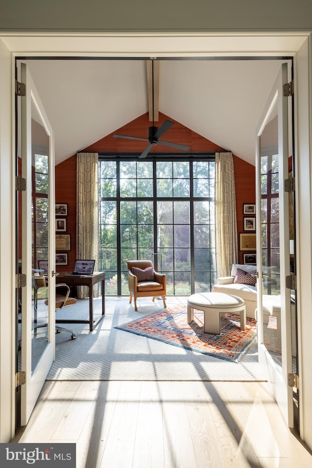 unfurnished sunroom with lofted ceiling with beams and ceiling fan