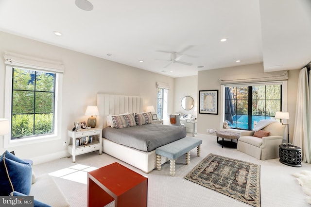 bedroom with carpet floors, multiple windows, and ceiling fan