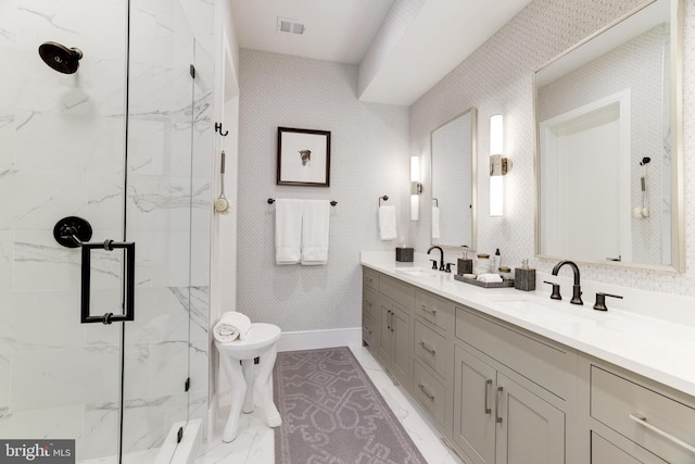 bathroom featuring vanity and a shower with door