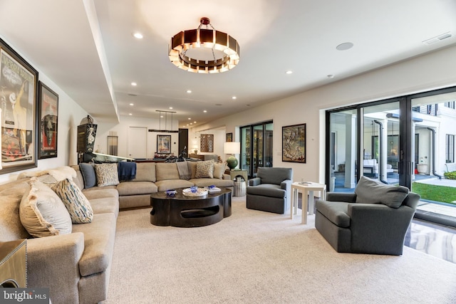 living room featuring a healthy amount of sunlight and light carpet