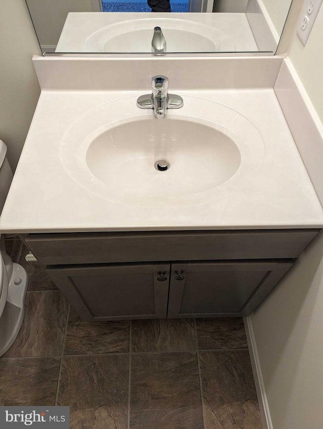 bathroom with vanity and toilet