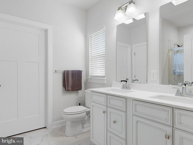 bathroom with vanity, toilet, and a shower with shower door