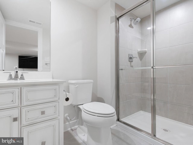 bathroom featuring vanity, walk in shower, toilet, and tile patterned floors