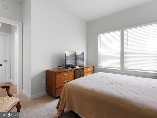 bedroom with light colored carpet