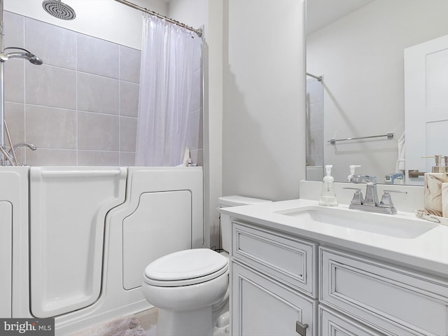 full bathroom featuring toilet, vanity, and shower / bathtub combination with curtain