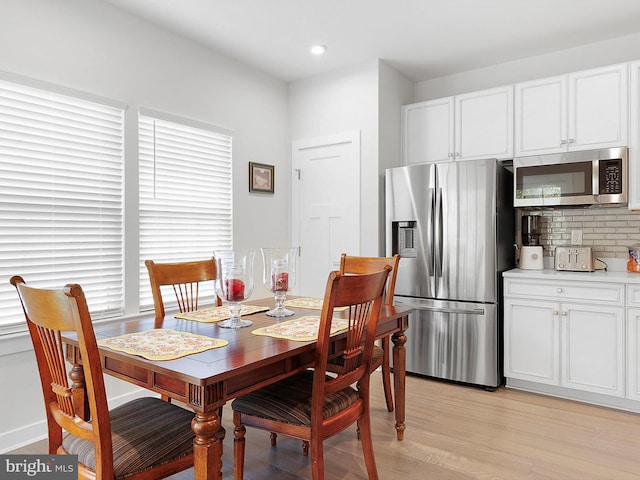 dining area with light hardwood / wood-style flooring