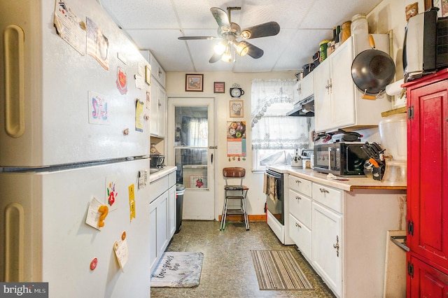 kitchen featuring a drop ceiling, white cabinetry, ceiling fan, and white appliances