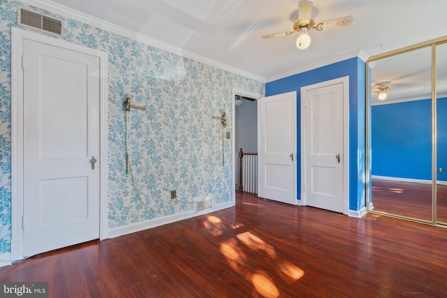 unfurnished bedroom with ornamental molding, dark wood-type flooring, and ceiling fan