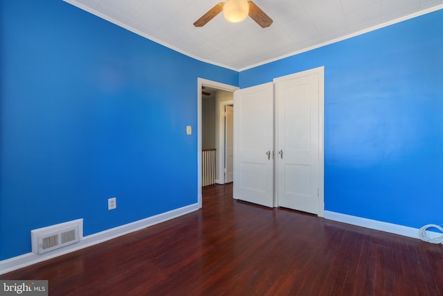 unfurnished bedroom with ceiling fan, crown molding, and dark hardwood / wood-style flooring