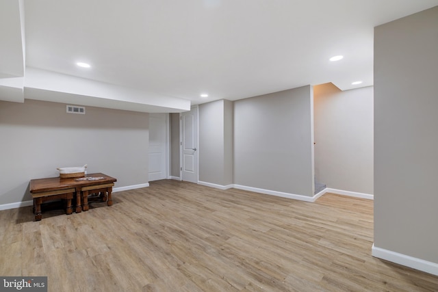 finished below grade area featuring wood finished floors, visible vents, recessed lighting, and baseboards