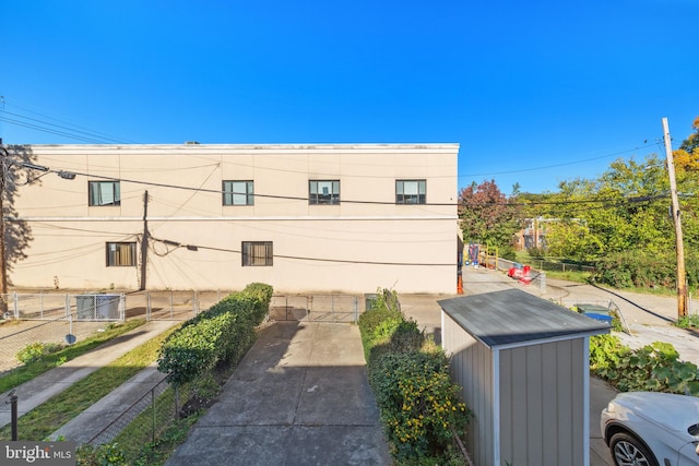 view of property exterior with a storage unit