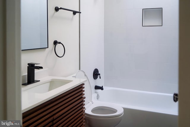 full bathroom with vanity, tiled shower / bath combo, and toilet