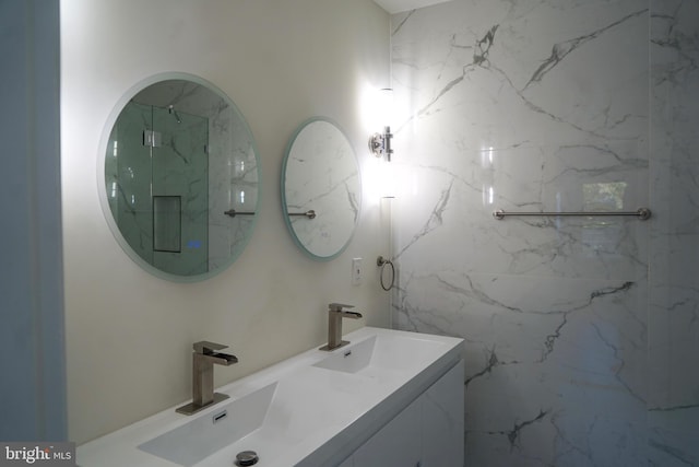 bathroom featuring a tile shower and vanity