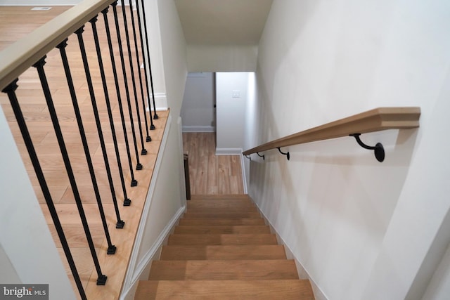 stairs with wood-type flooring