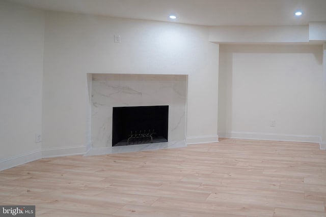 interior details with wood-type flooring and a fireplace