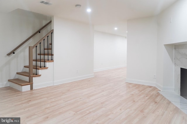 unfurnished living room featuring a fireplace and light wood-type flooring