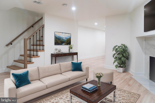 living room featuring light hardwood / wood-style flooring and a fireplace