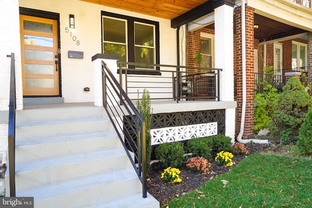 entrance to property featuring a porch