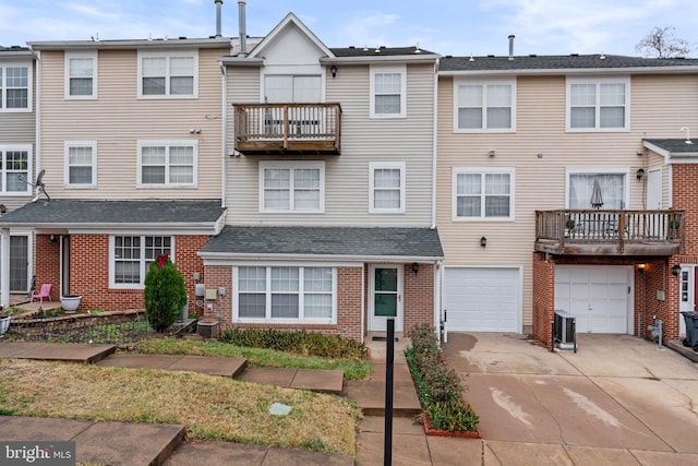 view of front facade featuring central AC unit and a garage