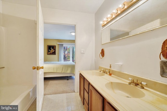 bathroom featuring vanity and a bath