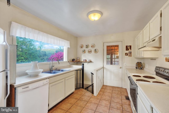 kitchen featuring light tile patterned flooring, white cabinets, sink, and white appliances