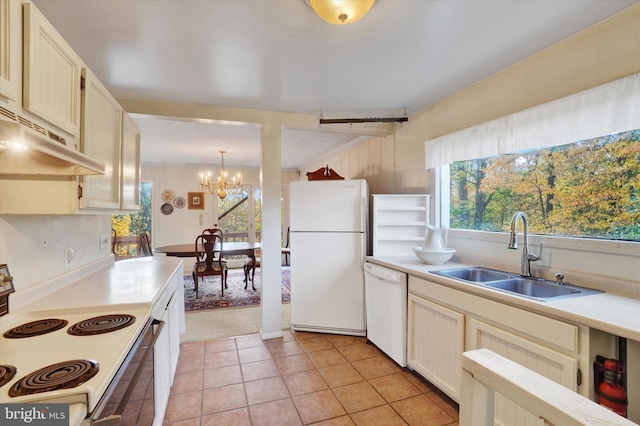 kitchen featuring sink, decorative light fixtures, light tile patterned floors, a chandelier, and white appliances