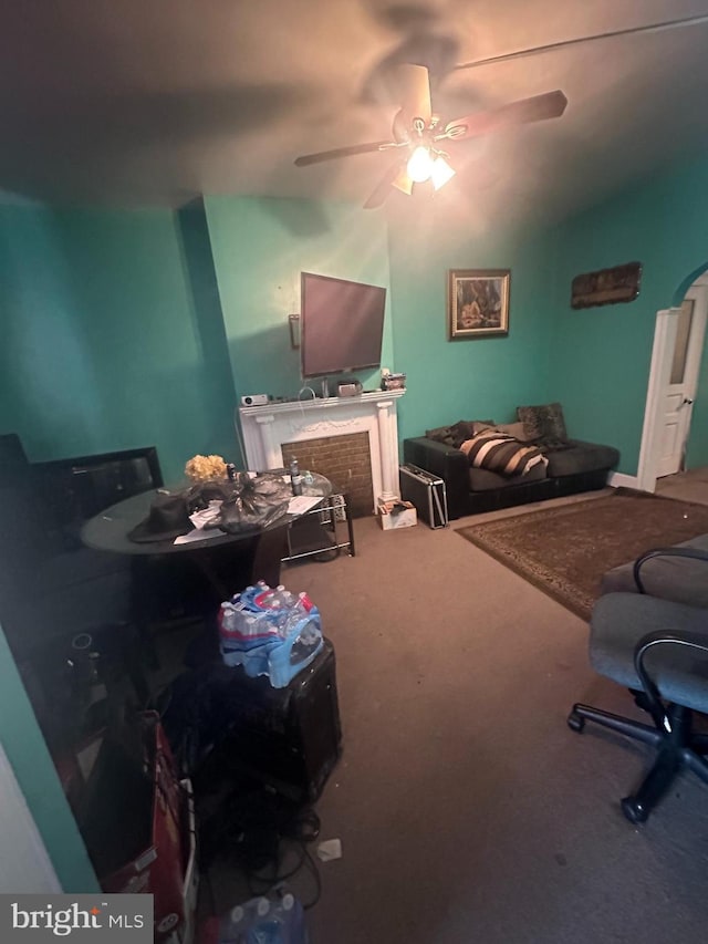 living room featuring carpet and ceiling fan