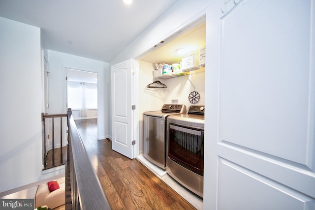 washroom with washing machine and dryer and dark hardwood / wood-style floors