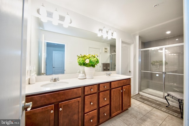 bathroom with vanity, tile patterned floors, and a shower with door