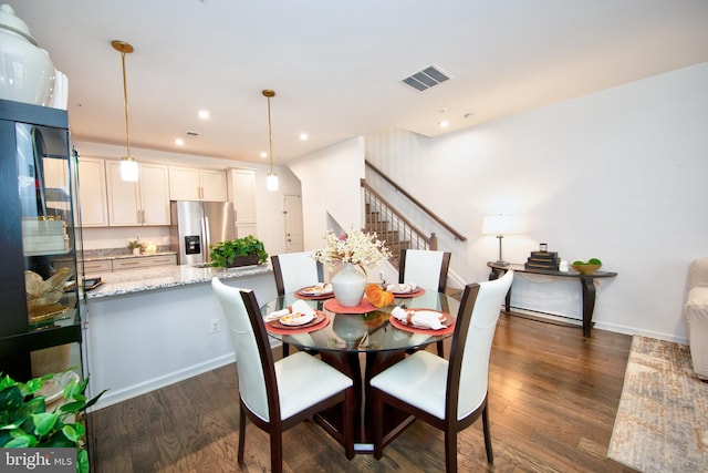 dining area featuring dark wood-type flooring