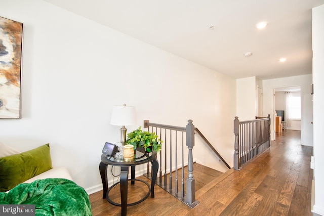 corridor with hardwood / wood-style flooring