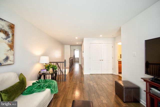 hallway with hardwood / wood-style floors