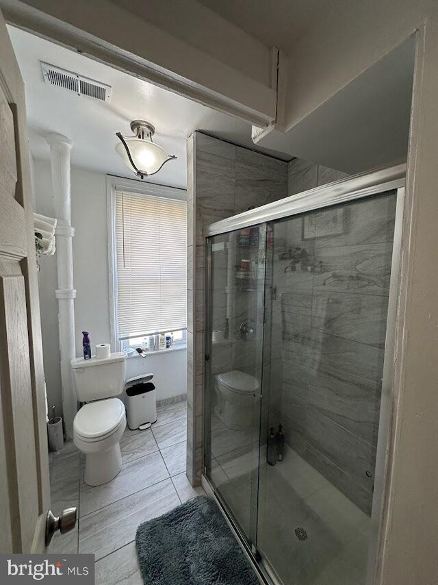901 W Princess St, York, PA 17403 - bathroom with visible vents, toilet, a stall shower, and decorative columns