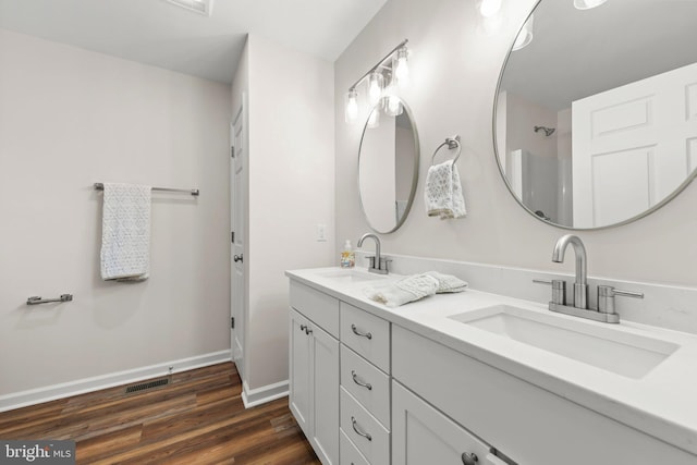 bathroom with hardwood / wood-style floors and vanity