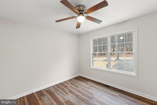 unfurnished room with ceiling fan and dark wood-type flooring