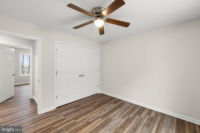 unfurnished bedroom featuring dark hardwood / wood-style flooring, a closet, and ceiling fan