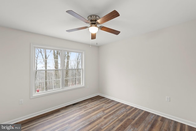 unfurnished room with ceiling fan and dark hardwood / wood-style flooring