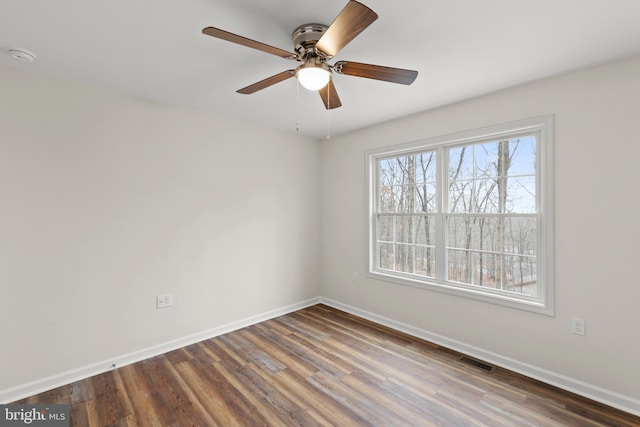 empty room featuring ceiling fan and dark wood-type flooring