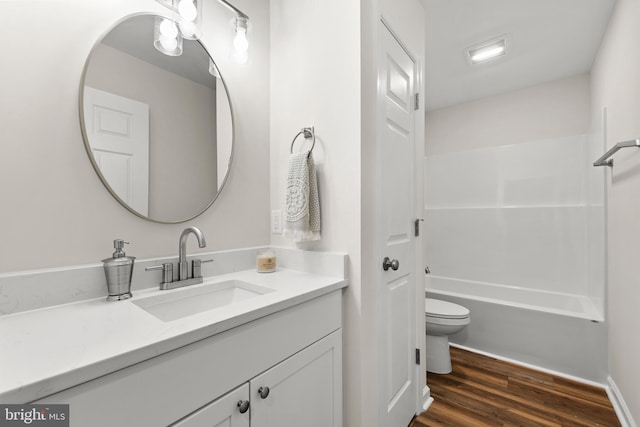 bathroom with hardwood / wood-style flooring, vanity, and toilet